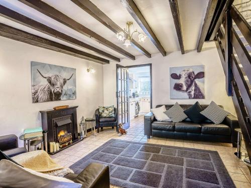 a living room with a couch and a fireplace at 3 Bed in Cenarth 79198 in Felindre