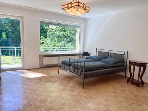 a bedroom with a bed and a large window at Large Munich house with 4 bedrooms in a quiet and greened villa area near Munich in Munich