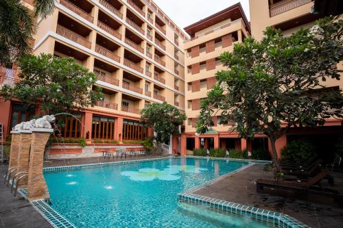 a swimming pool in the middle of a building at Sunday Chateau En Ville - Pattaya in Pattaya North