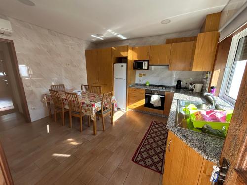 a kitchen and dining room with a table and chairs at Paradise Property,Ideal para ferias ou Lua de Mel in Albergaria-a-Velha