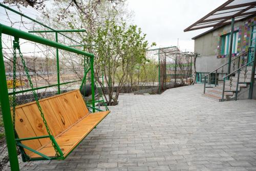 a wooden bench sitting next to a building at The Victorian Hotel & Spa Room 1 in Yerevan