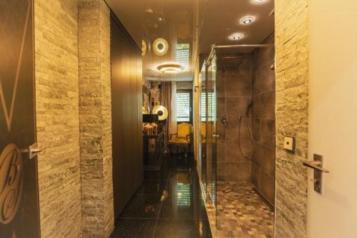 a bathroom with a walk in shower and a glass door at BS Milla Estate Heidelberg in Heidelberg