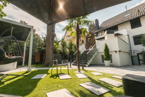a yard with a swing and a playground at BS Milla Estate Heidelberg in Heidelberg