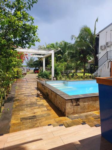 a swimming pool in the middle of a yard at Mercusuar Resort Jepara in Kesembu