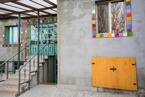 a building with a wooden door next to a staircase at The Victorian Hotel & Spa Room 1 in Yerevan