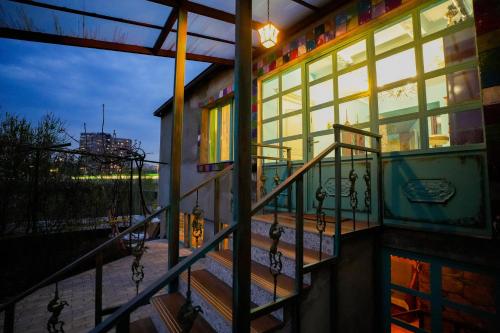 a building with a balcony with stairs and windows at The Victorian Hotel & Spa Room 1 in Yerevan