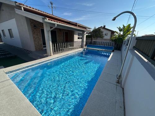 a swimming pool in front of a house at Paradise Property,Ideal para ferias ou Lua de Mel in Albergaria-a-Velha