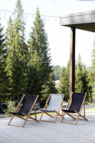 two lounge chairs sitting on a patio at Moho Будинки для відпочинку in Bukovel