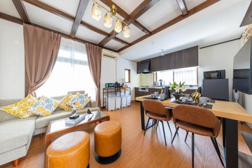 a living room with a couch and a table at Shinjuku 24mins train 4BR 8 Beds 2BA in Chofu