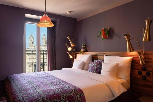 a bedroom with a large bed and a window at 25hours Hotel Terminus Nord in Paris