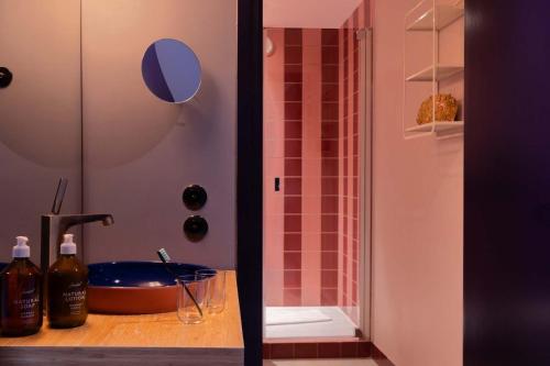 a bathroom with a sink and a shower at 25hours Hotel Terminus Nord in Paris