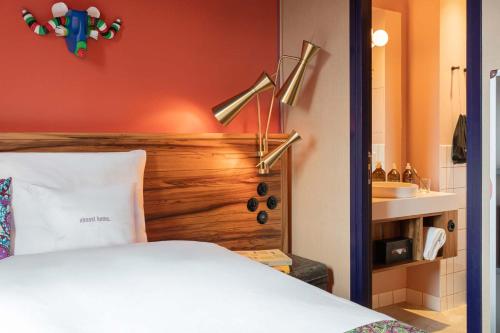 a bedroom with a white bed and a sink at 25hours Hotel Terminus Nord in Paris