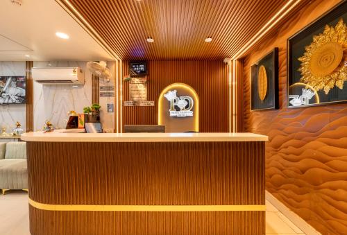 a bar in a salon with a brown wall at Hotel Prince Diamond in Varanasi