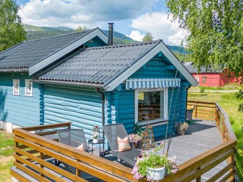 a blue tiny house with a wooden deck at The Blue Cabin in Trysil