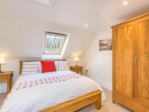 a bedroom with a bed and a wooden cabinet at 6 Bed in Applecross CA343 in Applecross