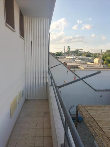 a balcony with a view of a building at AriadiMare in Torre Ovo