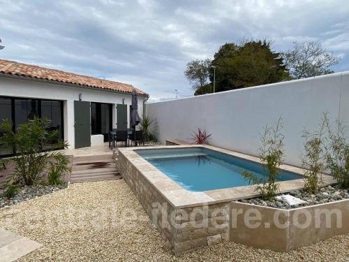 una piscina en el patio trasero de una casa en La Villa Alamy, en Le Bois-Plage-en-Ré