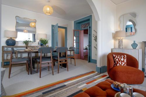 a living room with a dining room table and chairs at Admirals Hard in Budleigh Salterton