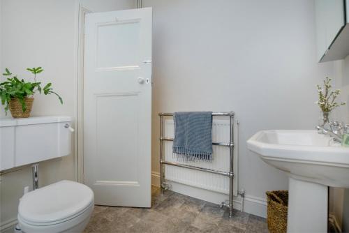 a bathroom with a toilet and a sink at Admirals Hard in Budleigh Salterton