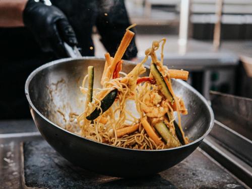 a bowl filled with noodles and shrimp on a counter at Mercure Arras Centre Gare in Arras