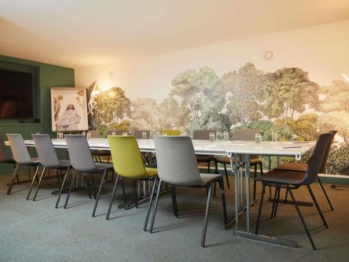 a conference room with a long table and chairs at Mercure Arras Centre Gare in Arras