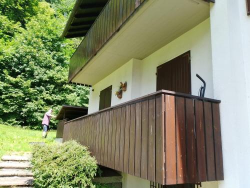 a house with a wooden deck on the side of it at Piera' s House in Caderzone