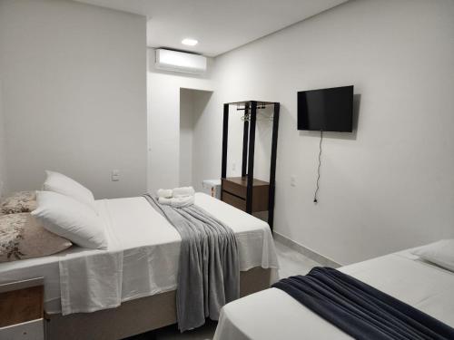 Ένα ή περισσότερα κρεβάτια σε δωμάτιο στο Hospedagens Rebouças