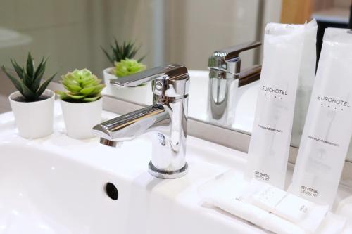 a bathroom sink with a faucet on a counter at Eurohotel Diagonal Port in Barcelona
