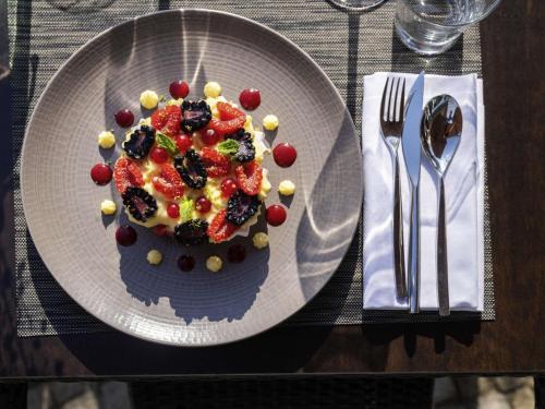 a plate with a fruit dessert on a table at Novotel Nantes Centre Gare in Nantes