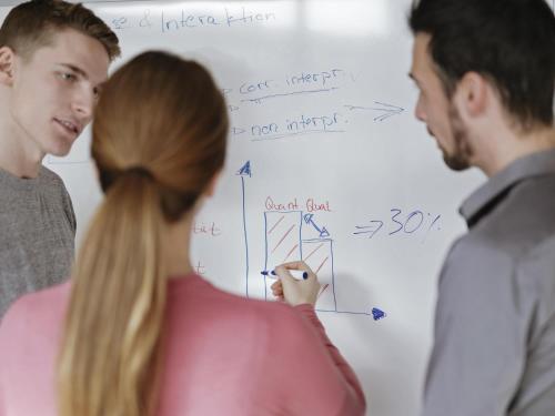 a group of people standing in front of a whiteboard at ibis Berlin City Nord in Berlin