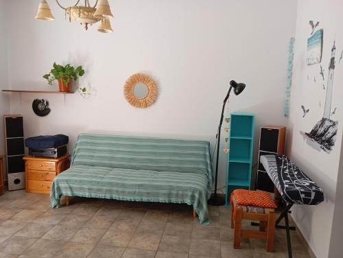 a room with a bed and a desk and a lamp at Moon River in Aegina Town