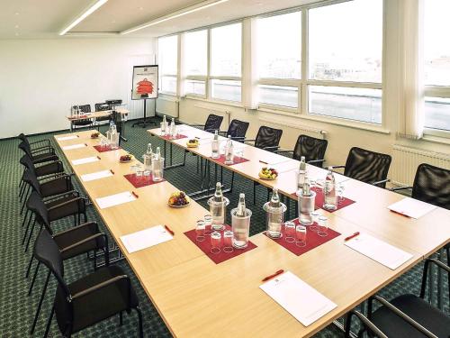 a large conference room with a long table and chairs at ibis Dresden Zentrum in Dresden
