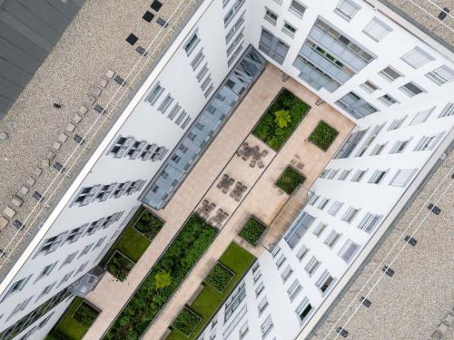 an overhead view of a tall white building with plants at Mercure Hotel Stuttgart Airport Messe in Stuttgart