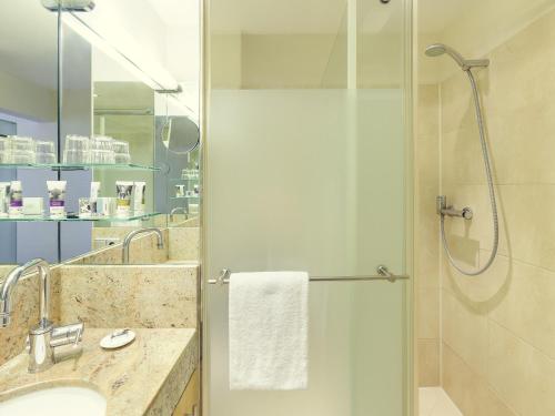 a bathroom with a shower and a sink at Mercure Hotel Potsdam City in Potsdam