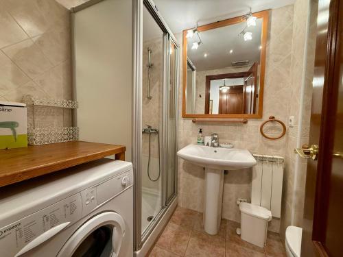 a bathroom with a washing machine and a sink at C19 - Bellavista Pirineo - Villmor in Cerler