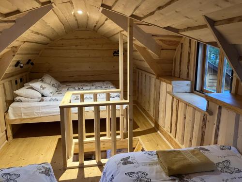 an attic bedroom with two beds in a room at Neitsijärve majutus in Otepää