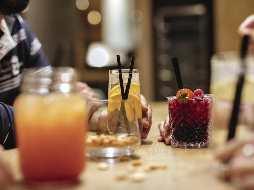 a group of people sitting at a table with drinks at Mercure Hotel Potsdam City in Potsdam