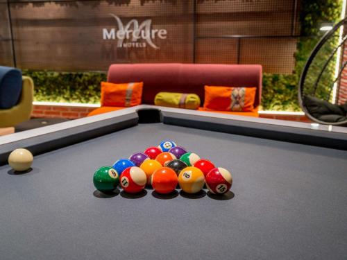 a pile of billiard balls on a pool table at Hotel Mercure Toulouse Centre Compans in Toulouse