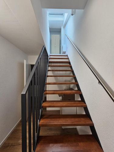 a staircase in a house with wooden steps at Cosy private room in Lausanne center in Lausanne
