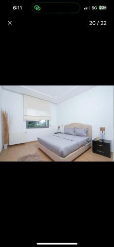 a picture of a bedroom with a large bed at RDC Villa avec Jardin & Piscine Privée in El Aouina Station