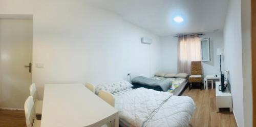 a living room with a bed and a couch at Casita de campo in Albacete