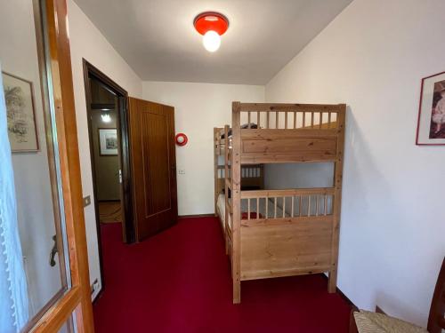 a hallway with a staircase and a room with a door at Ampio appartamento per 8 a due passi dal centro in Bardonecchia