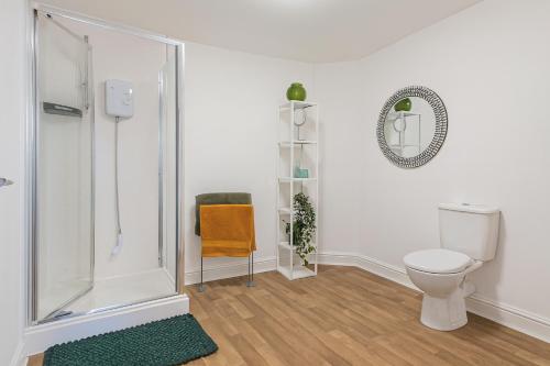 a bathroom with a shower and a toilet at 1 Bed - Sleeps 4 - City Centre in Wolverhampton