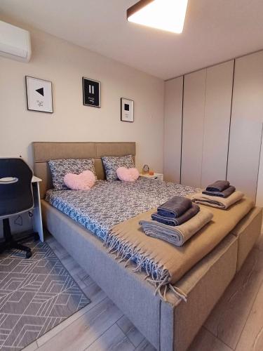 a bedroom with a large bed with pink pillows at Your Home in Plovdiv with Free Private Parking in Plovdiv