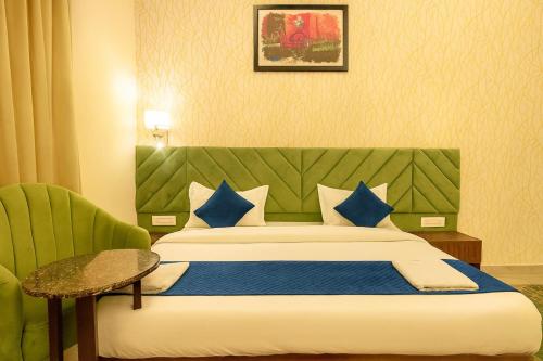 a hotel room with a bed and a chair at Hotel Pawan Regency- Best Mountain View Hotel In McLeodganj in McLeod Ganj