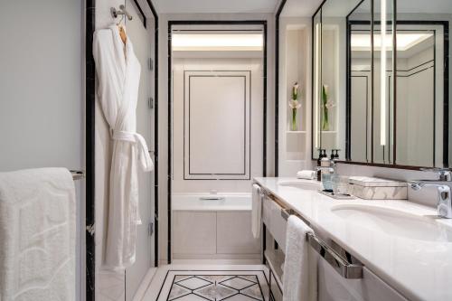 a white bathroom with a sink and a mirror at Shangri-La Hongqiao Airport,Shanghai in Shanghai