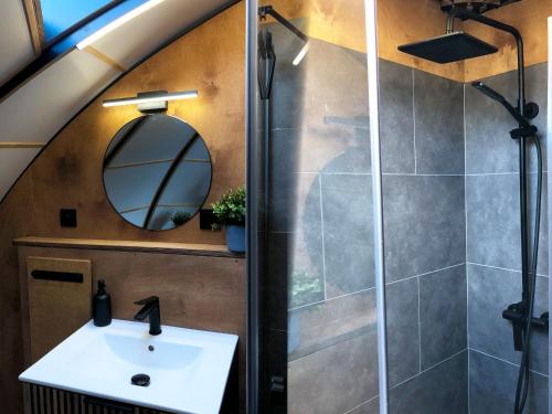 a bathroom with a sink and a shower at Osada Marchowo in Kielno