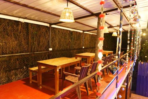a room with two tables and chairs and a ceiling at Broad Bean Royal Resort Goa in Canacona