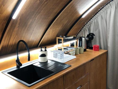 a kitchen with a sink and a counter top at Osada Marchowo in Kielno
