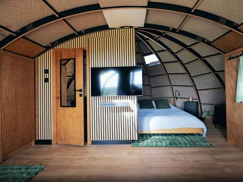 a large room with a bed and a tv in it at Osada Marchowo in Kielno